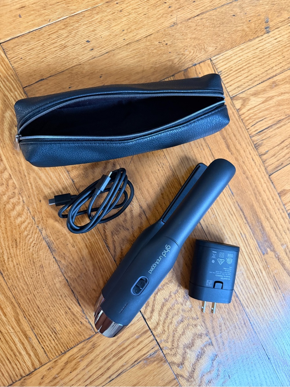 ghd unplugged mini flat iron in black with case, cord, and plug